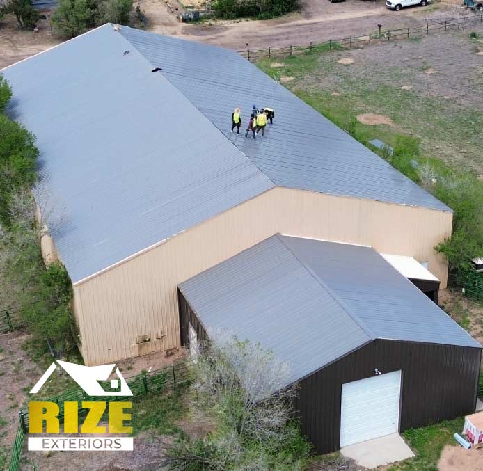 metal-roofing-work View of a completed commercial metal roof with seamless panels and reflective finishes