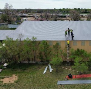 How long does a metal roof last? A Complete Guide 1 roofers on metal roof